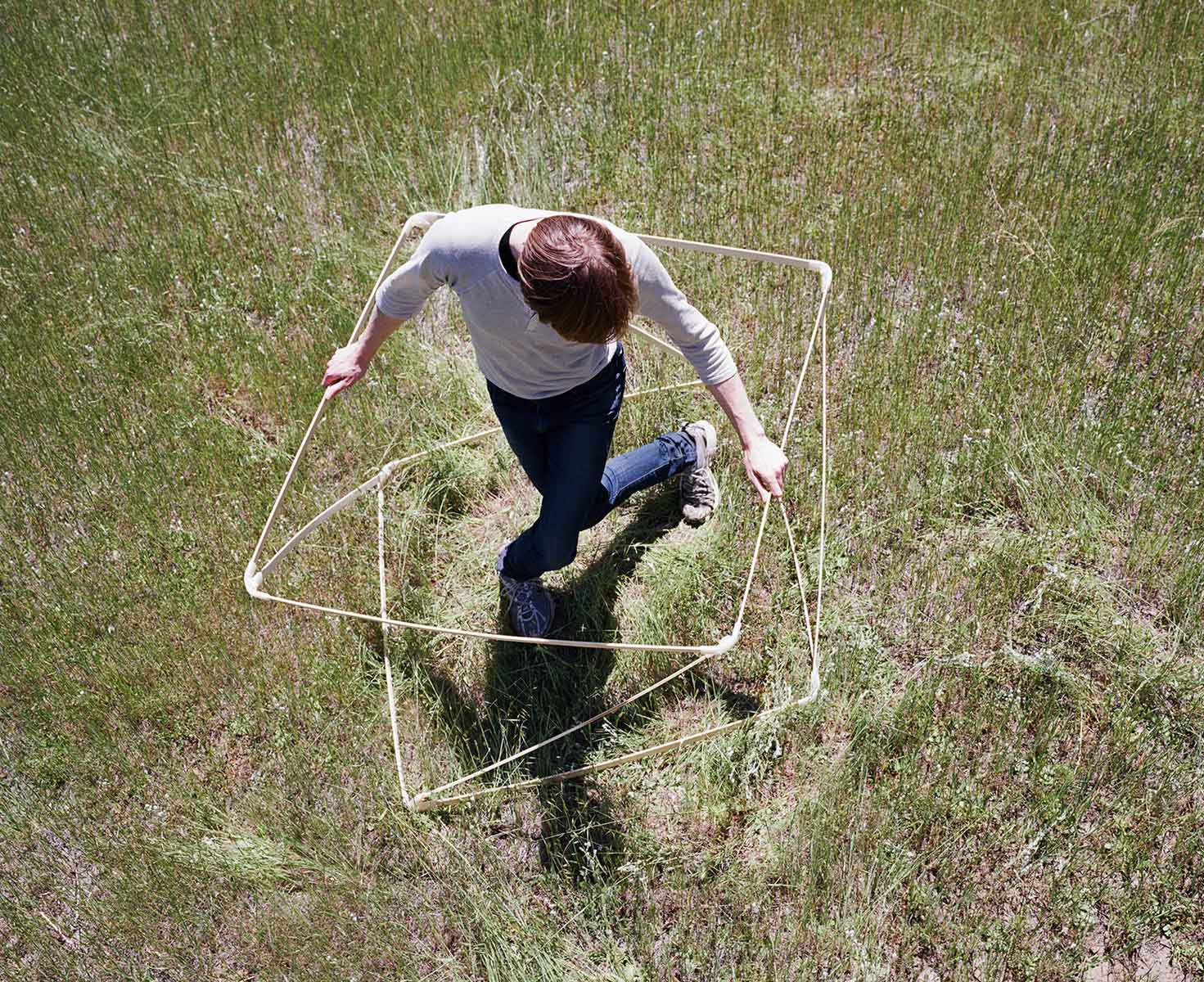 Data scientist Siobhán K. Cronin tests the geometric boundaries of designer Maria Blaisse’s bamboo cube. Photo: Terri Lowenthal for Slow Research Lab